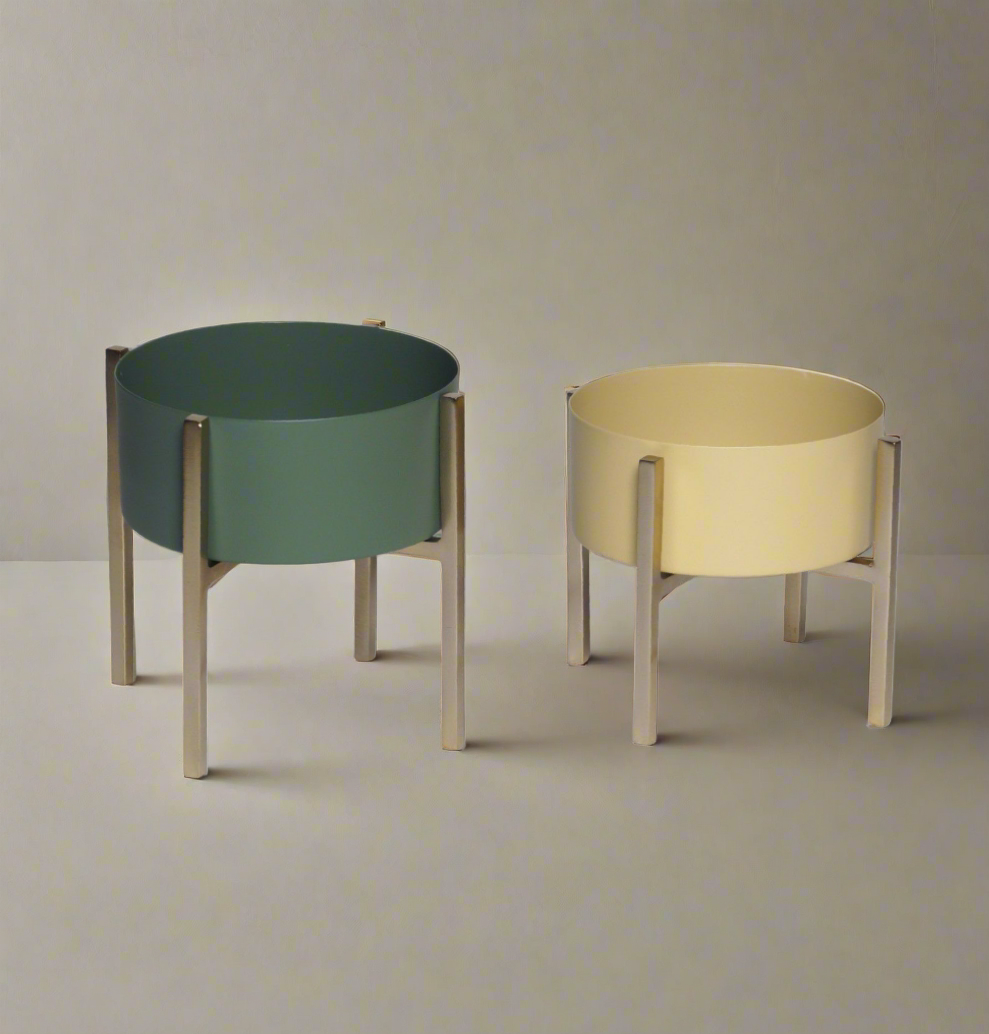 Two detachable stand metal bowls in green and cream colors with silver stands by Samaa India