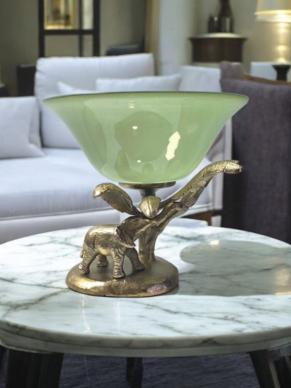 Luxury decorative bowl with green glass and golden elephant base on marble table from Samaa India