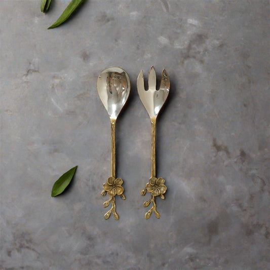 Decorative brass salad server set with floral handles by Samaa India on gray background