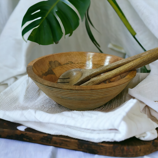 Samaa India wooden engraved salad bowl with matching wooden serving utensils on white cloth